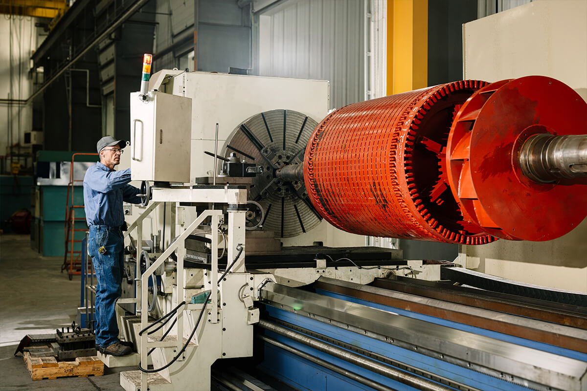 An H&N Electric skilled technician performing industrial electrical maintenance of a generator component