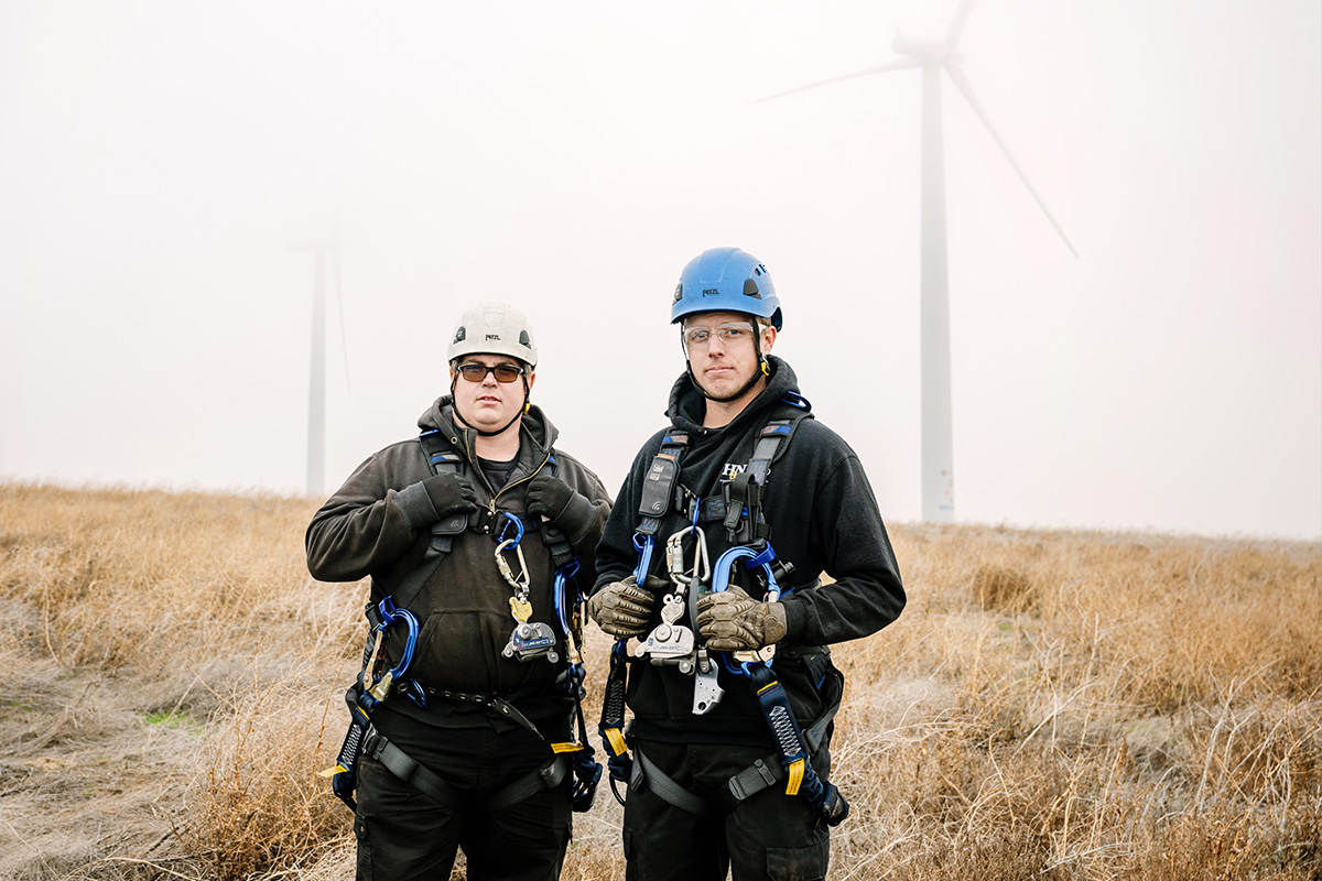 Two H&N Electric field service technicians on-site ready with equipment and safety gear to fix up-tower wind turbines