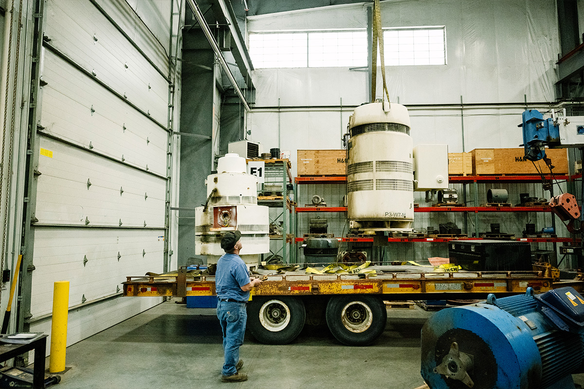 H&N Electric technician guiding the crane carrying a large industrial component in the fully-equipped Pasco, Washington facility