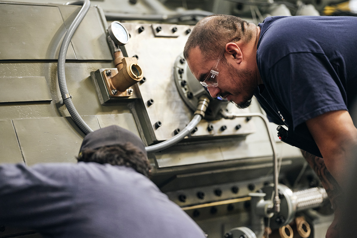 Two H&N technicians inspect an industrial gearbox