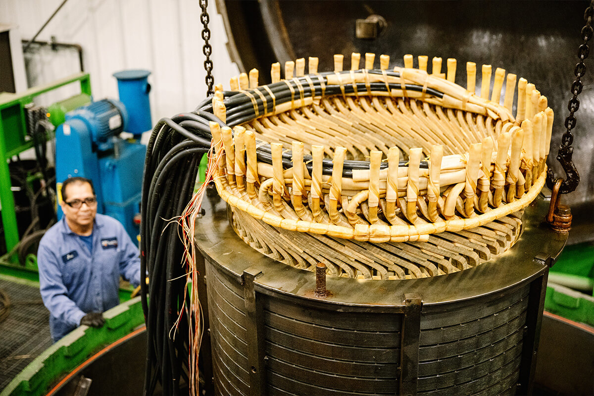 An H&N Electric technician observes as an electrical generator is hot-dipped at their on-site facility