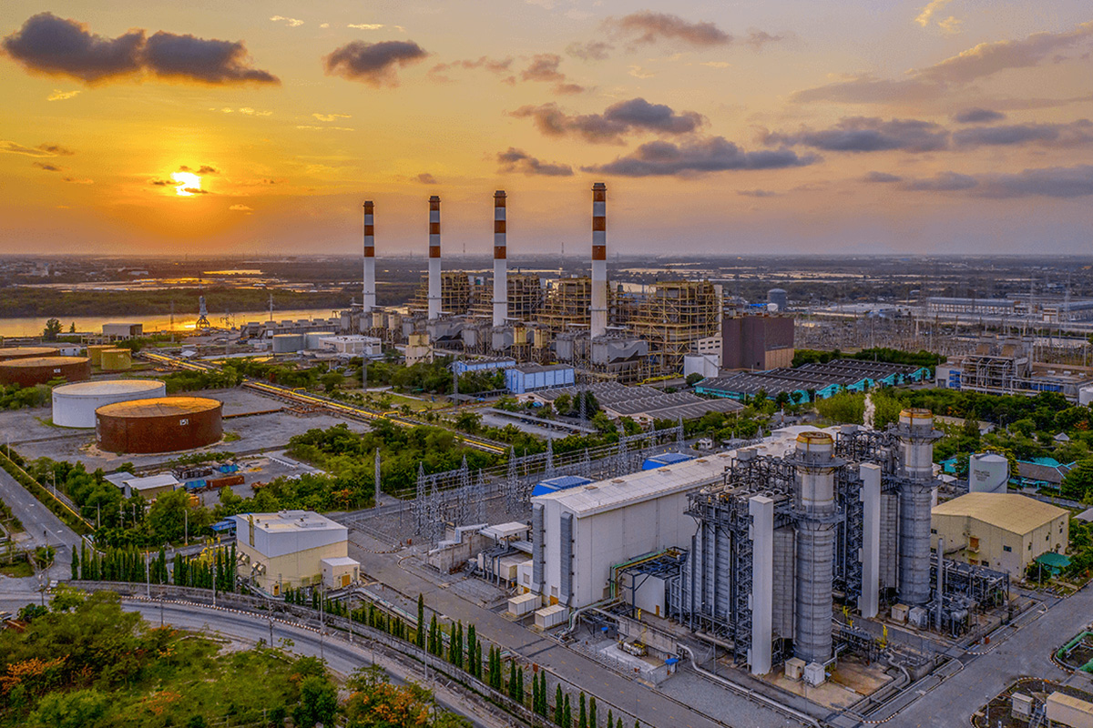 Wide shot of a power generation plant as sunset