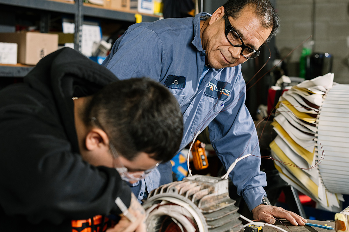 Two H&N Electric technicians working on coiling a small electrical generator